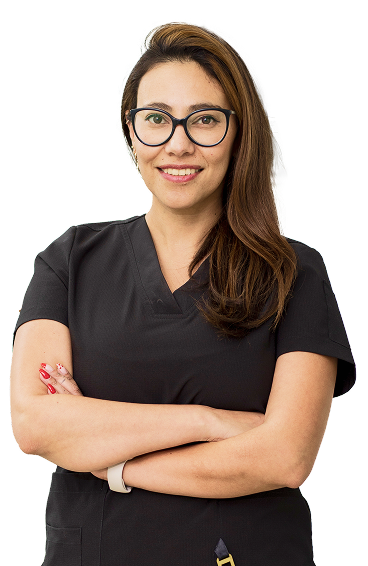 Rectangle 21 Confident dental professional smiling with arms crossed, wearing black scrubs and glasses